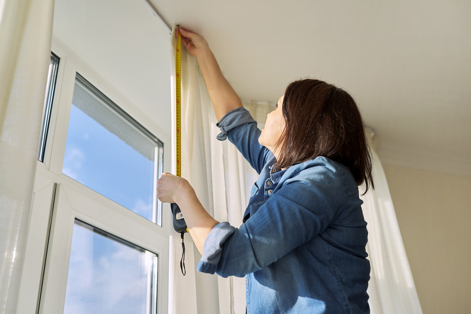 Measuring curtain length at a window