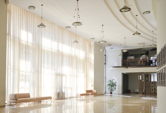 Floor-to-ceiling linen curtains hung high to make windows look taller