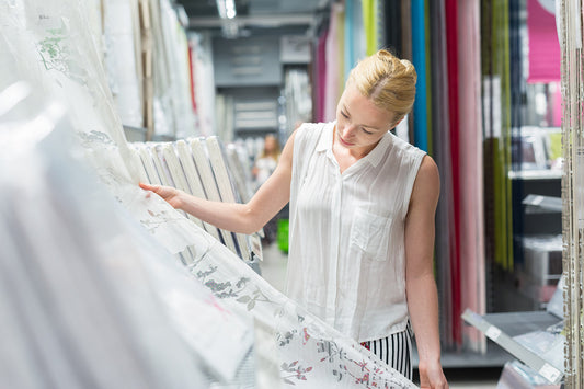 a woman selecting curtains in the store