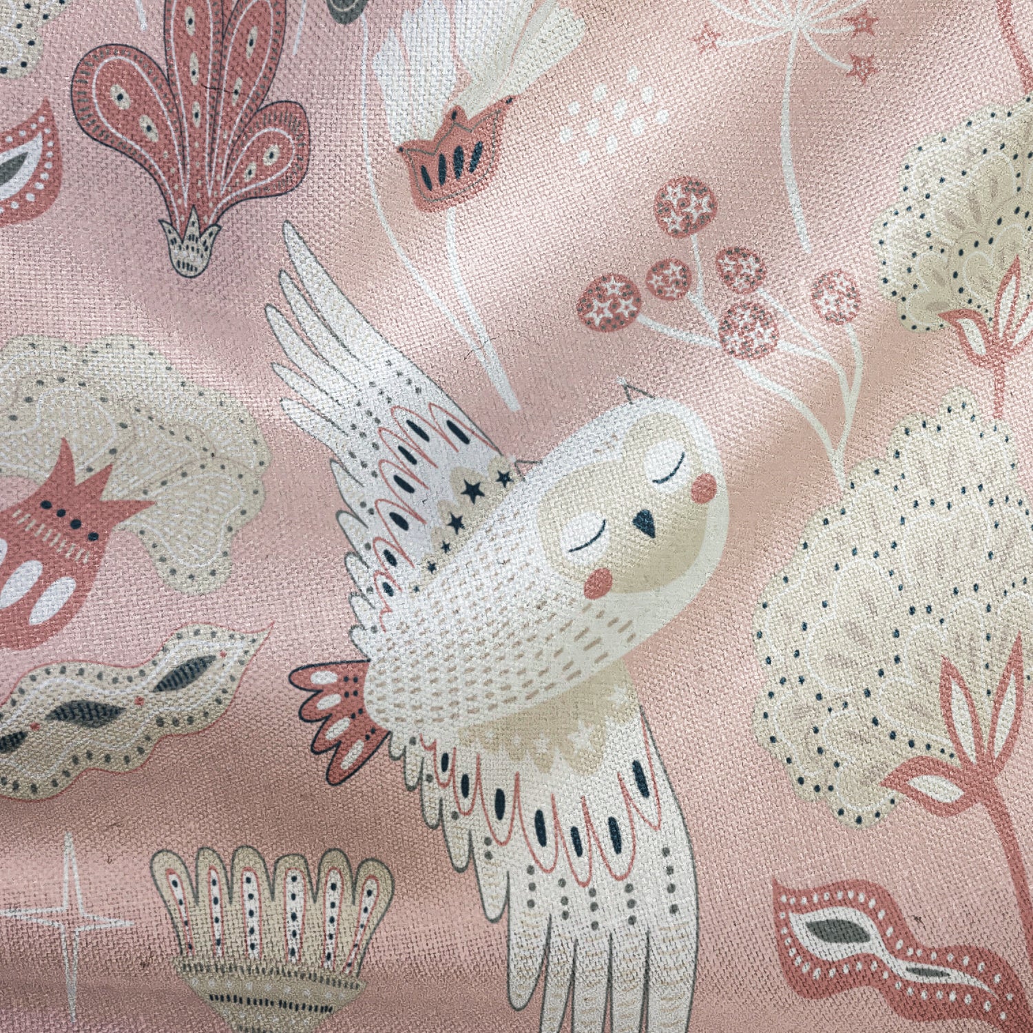 Decorative fabric with an owl and floral pattern on a pink background