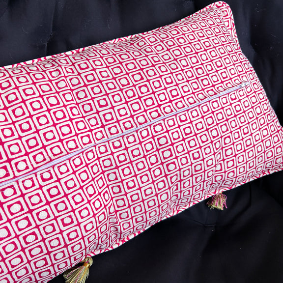 Red and white patterned pillow on a dark background