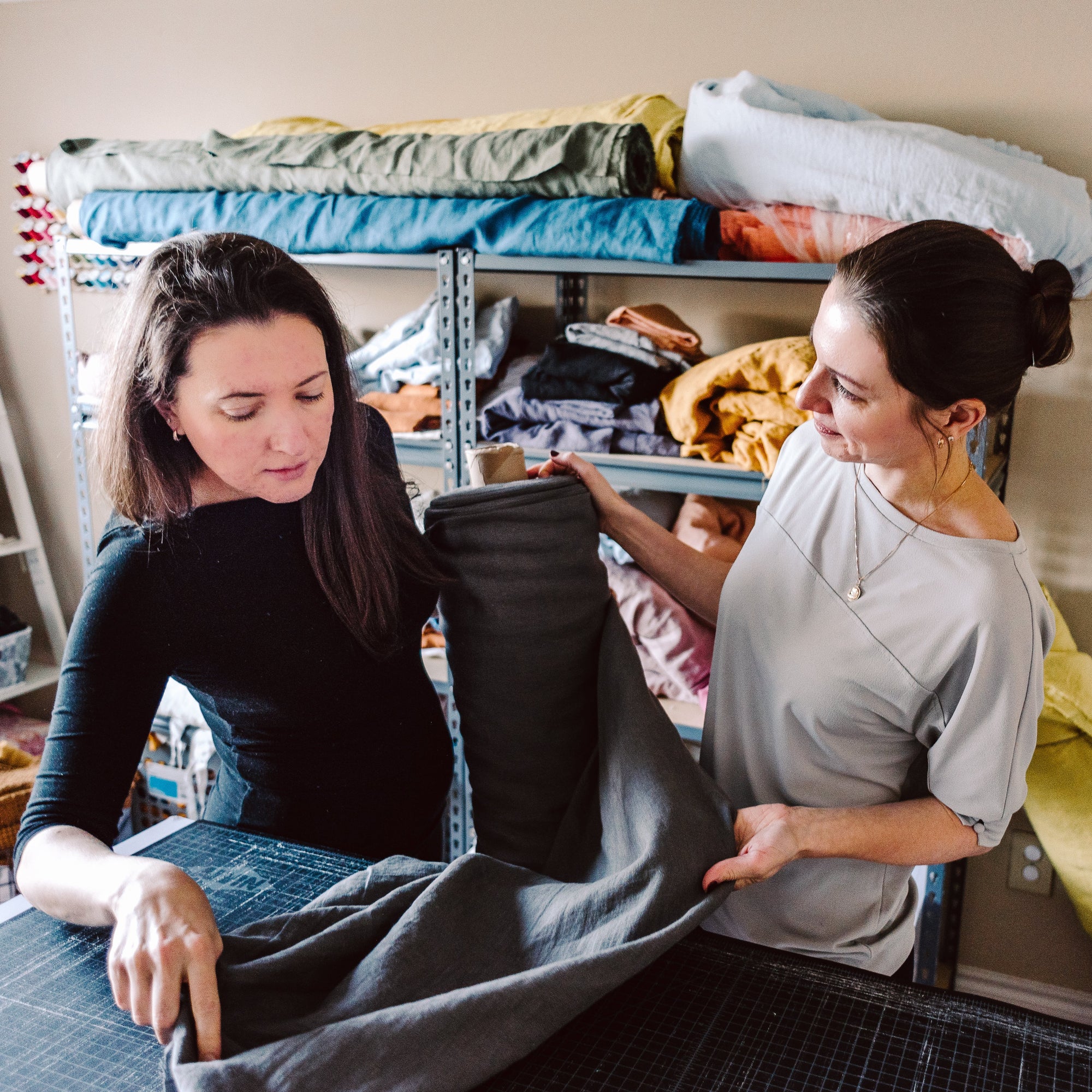 Two ladies looking at the fabric