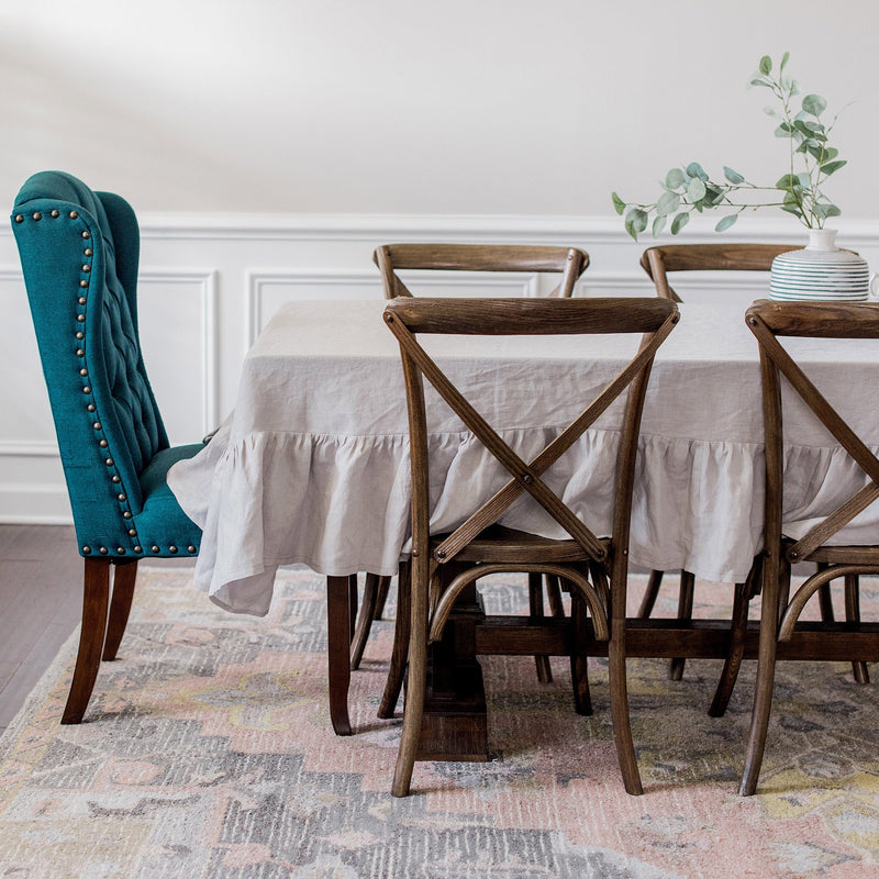 Dining room with a table, chairs, and a teal chair.