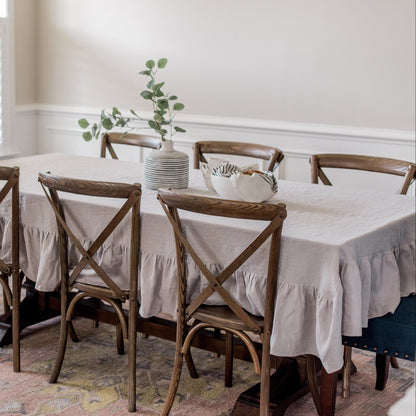 Dining room with a table and chairs set against a neutral wall.