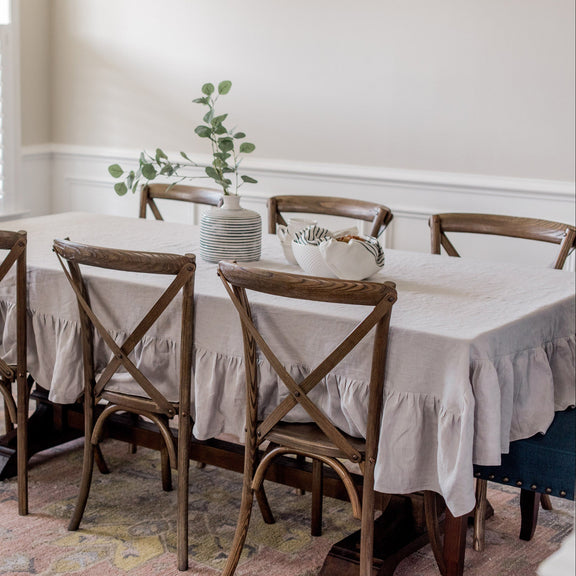 Dining room with a table and chairs set against a neutral wall.