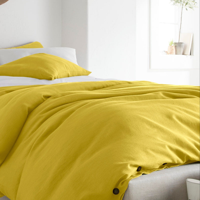 Yellow bedding set on a bed in a bright bedroom