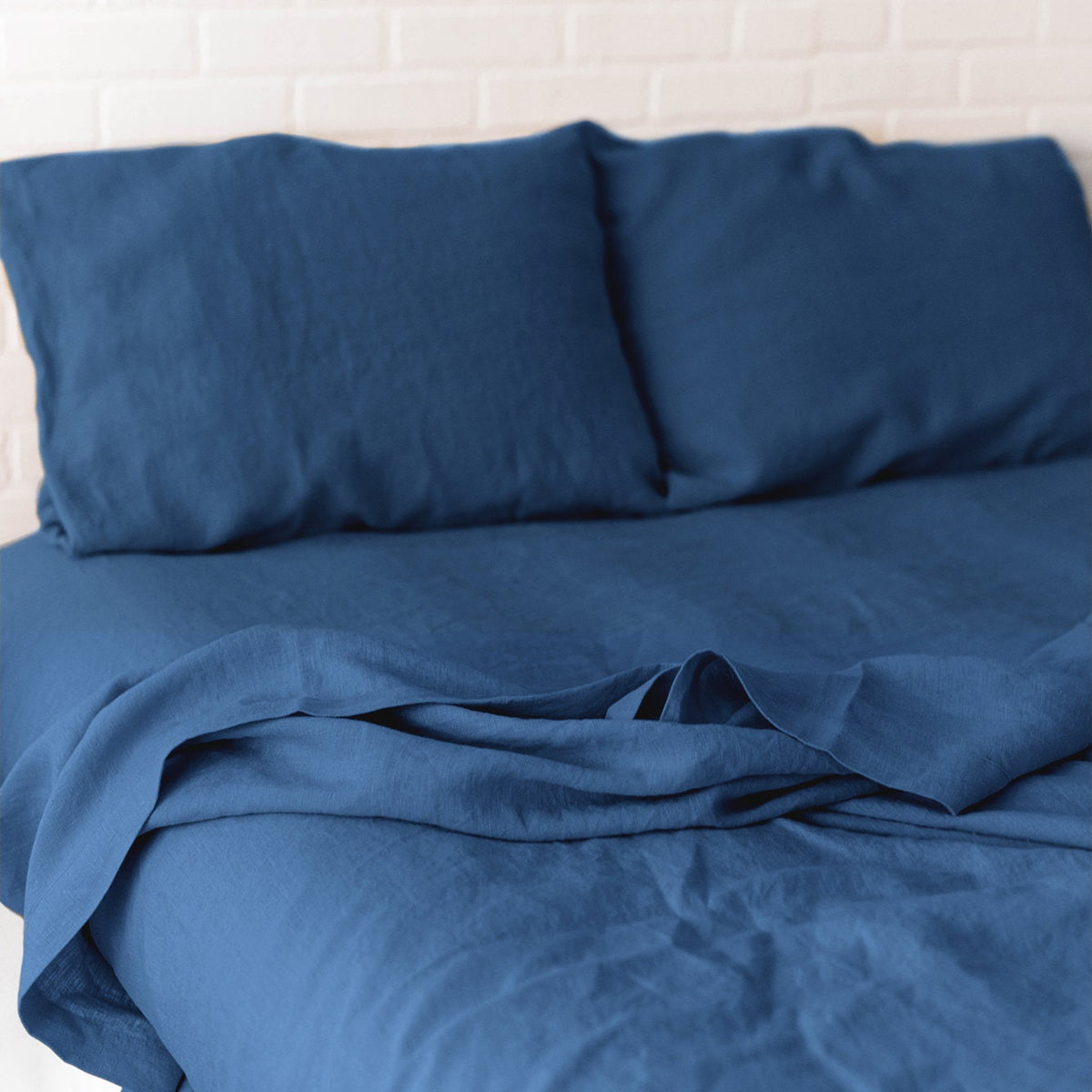 Blue bedding set with pillows on a white background