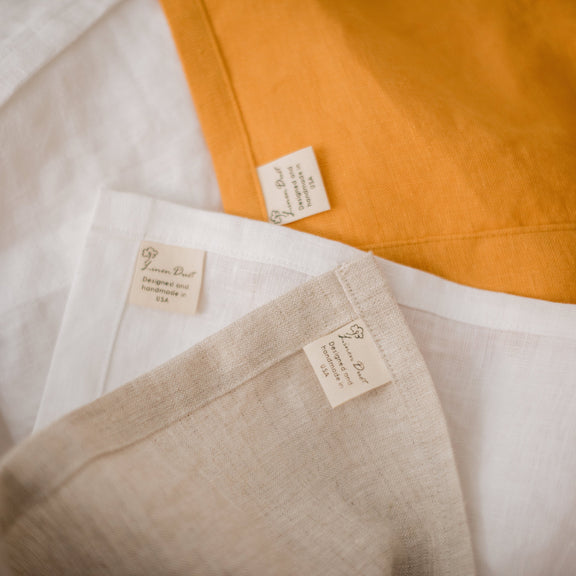 Close-up of fabric with visible labels on a white and orange background