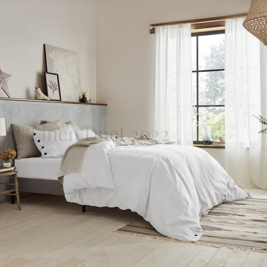 Neatly made bed in a bedroom with light decor