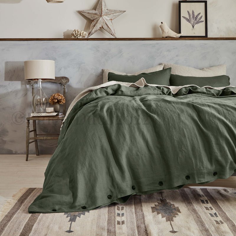 Green bedding set on a bed in a bedroom with decorative elements.
