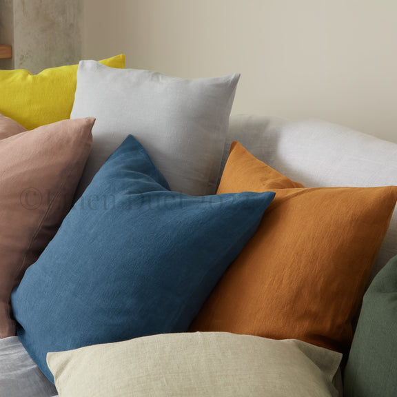 Colorful pillows on a sofa against a neutral background