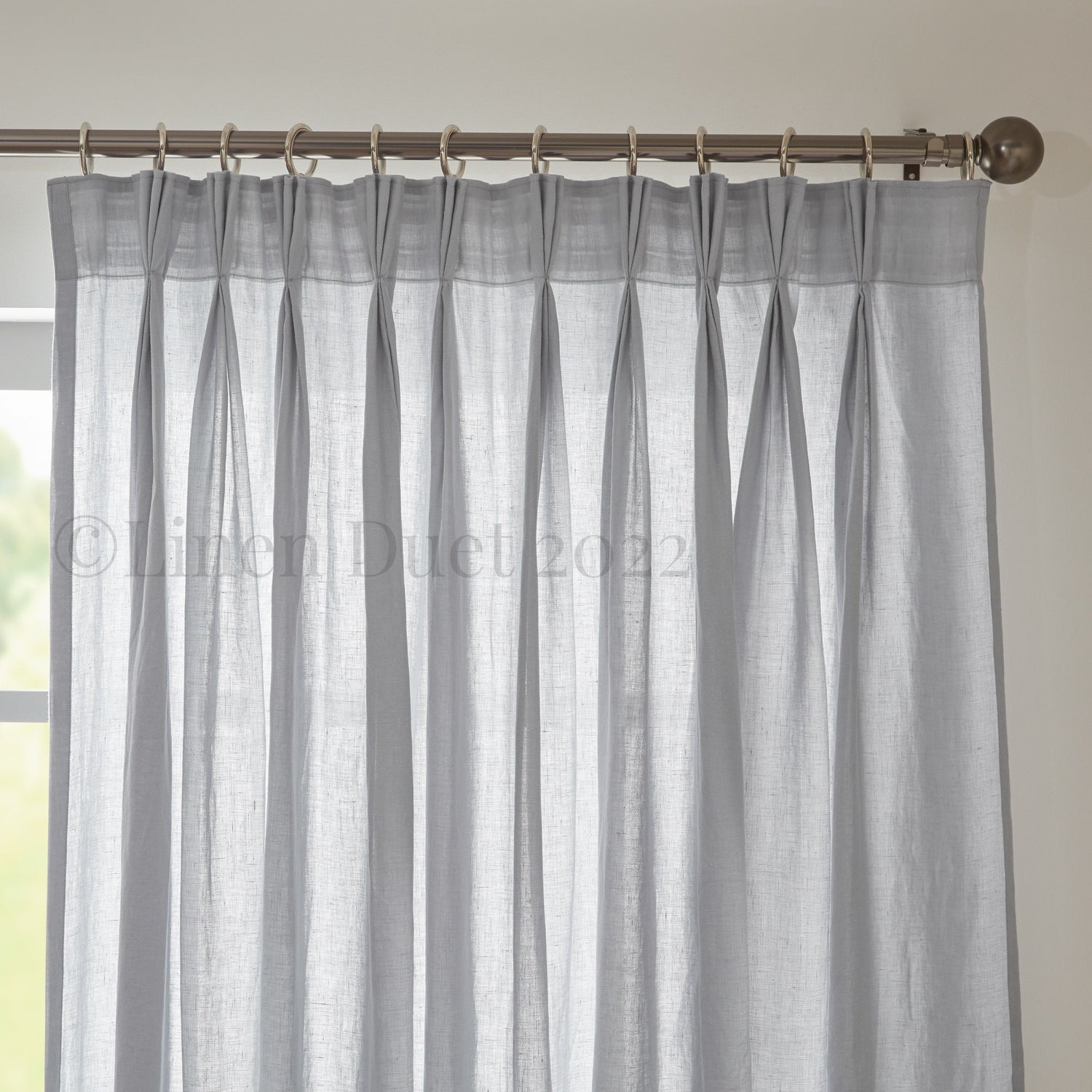 Curtain hanging from rings on a decorative rod