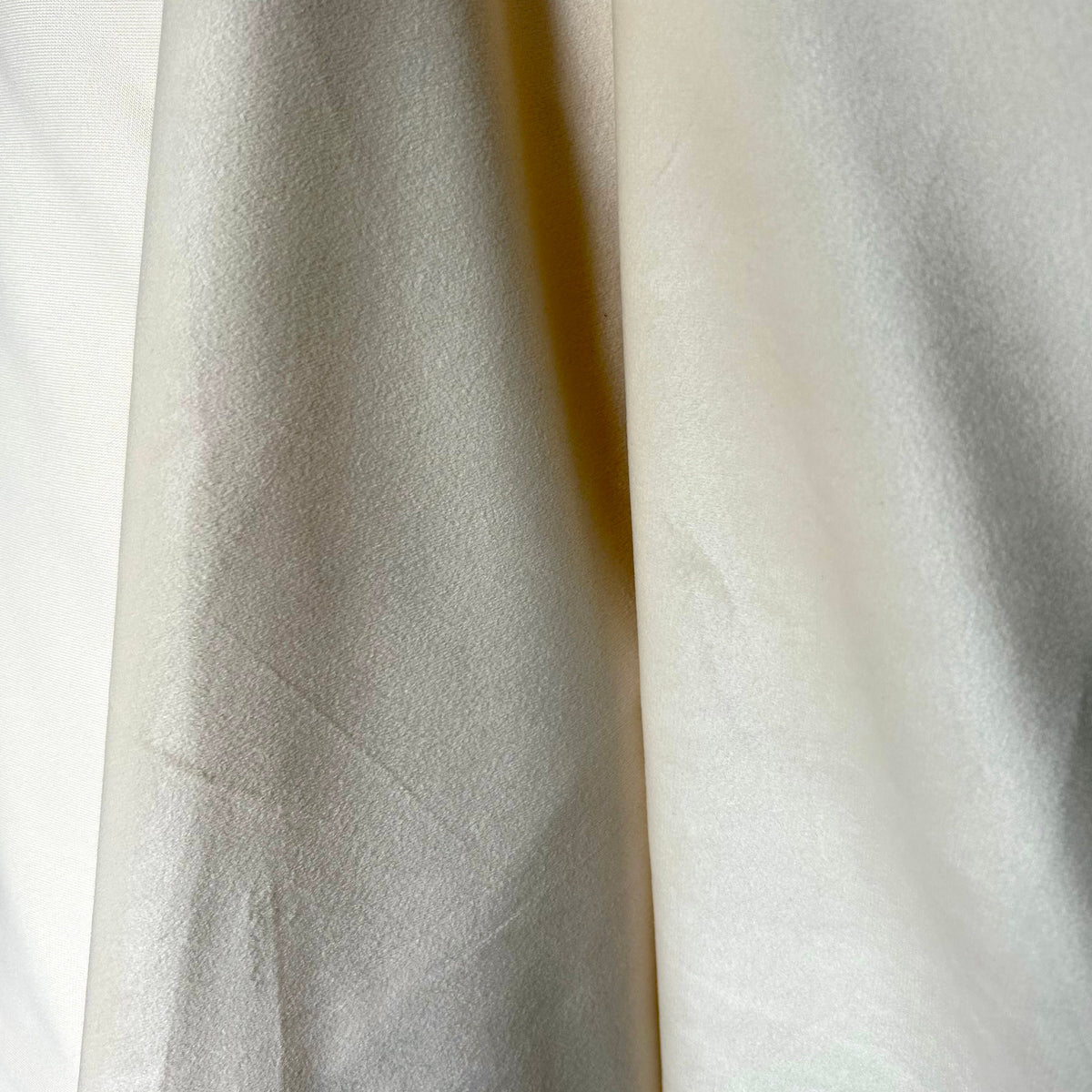Close-up of textured white fabric with a subtle pattern