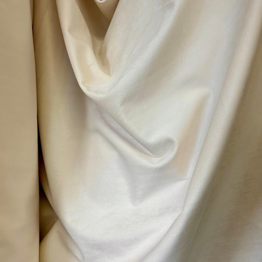 Close-up of beige and white fabric with folds