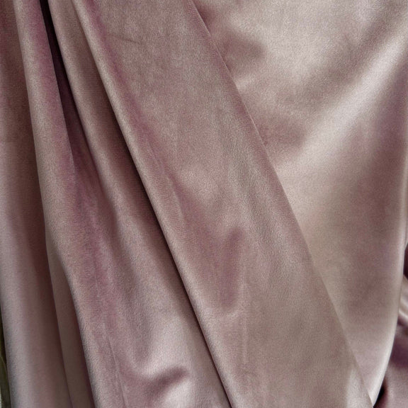 Close-up of pink velvet fabric with a soft texture