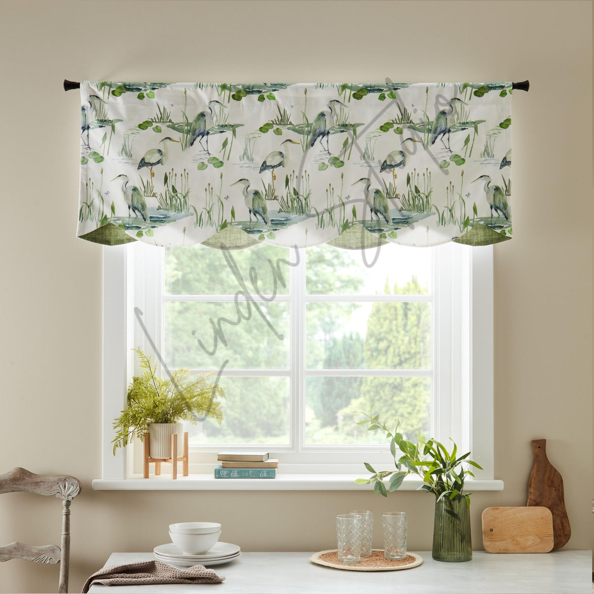 Window valance with nature-themed design above a kitchen window with decor items.