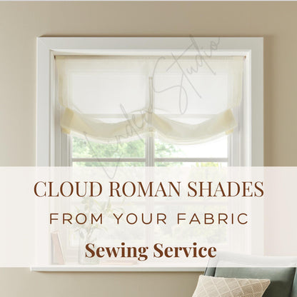 Window with cloud roman shades and text about fabric sewing service