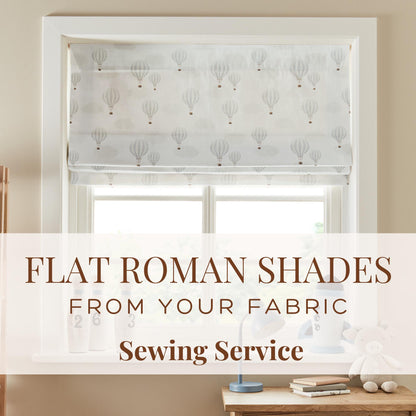 Window with flat roman shade featuring hot air balloon pattern, text overlay about fabric sewing service.
