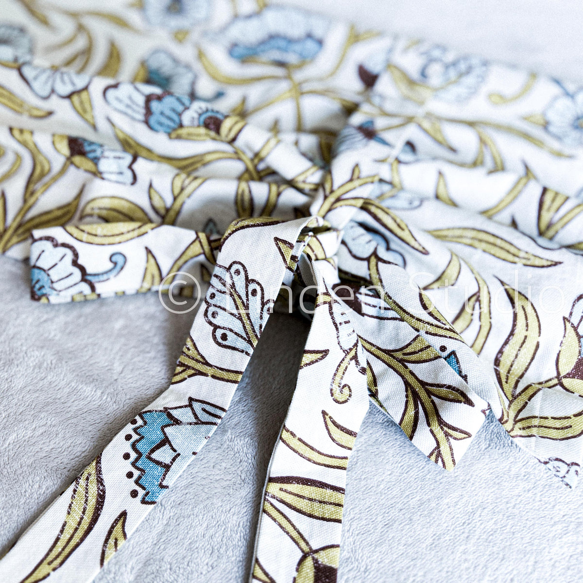 Close-up of window valance with floral pattern.