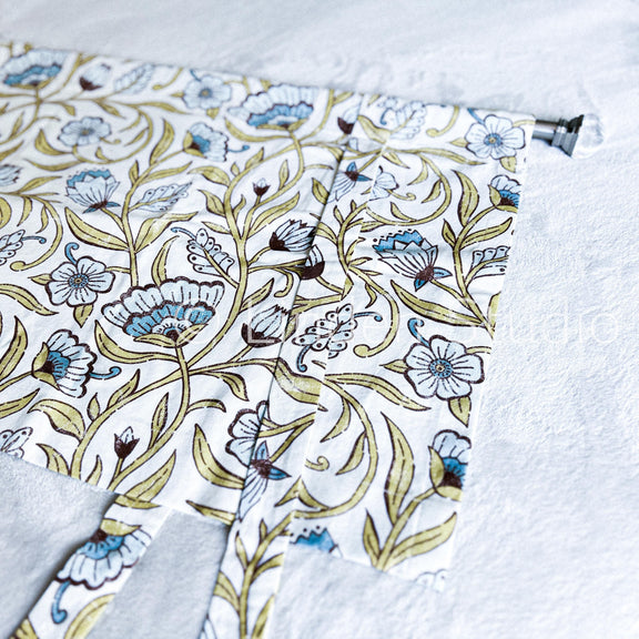 Floral patterned fabric with a visible brand name on a white background
