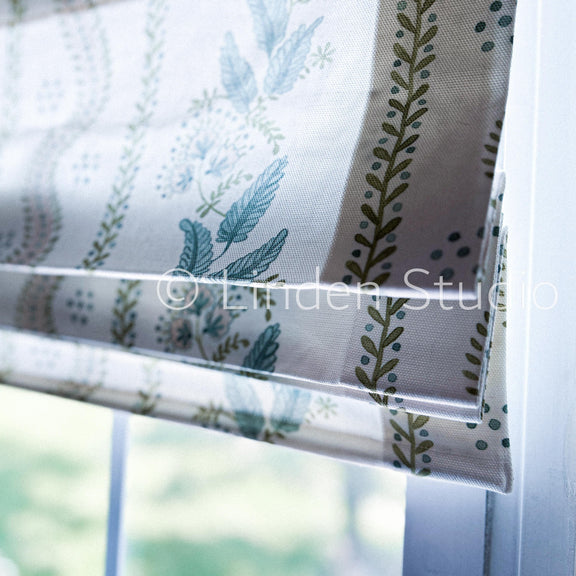 Window blind with leaf pattern in front of a window