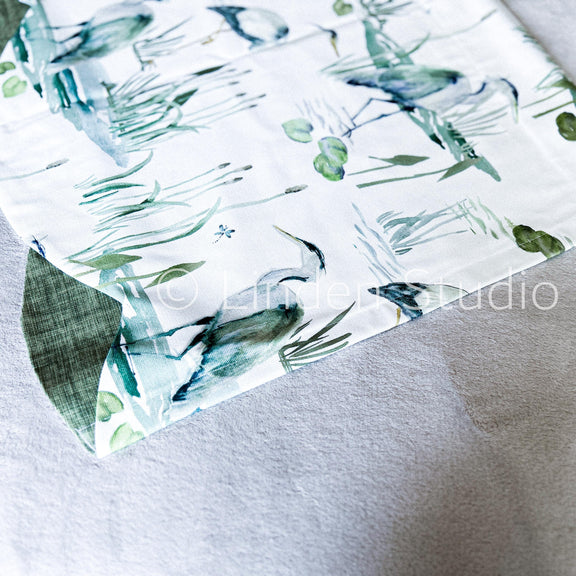Fabric with green leaf pattern on a white background
