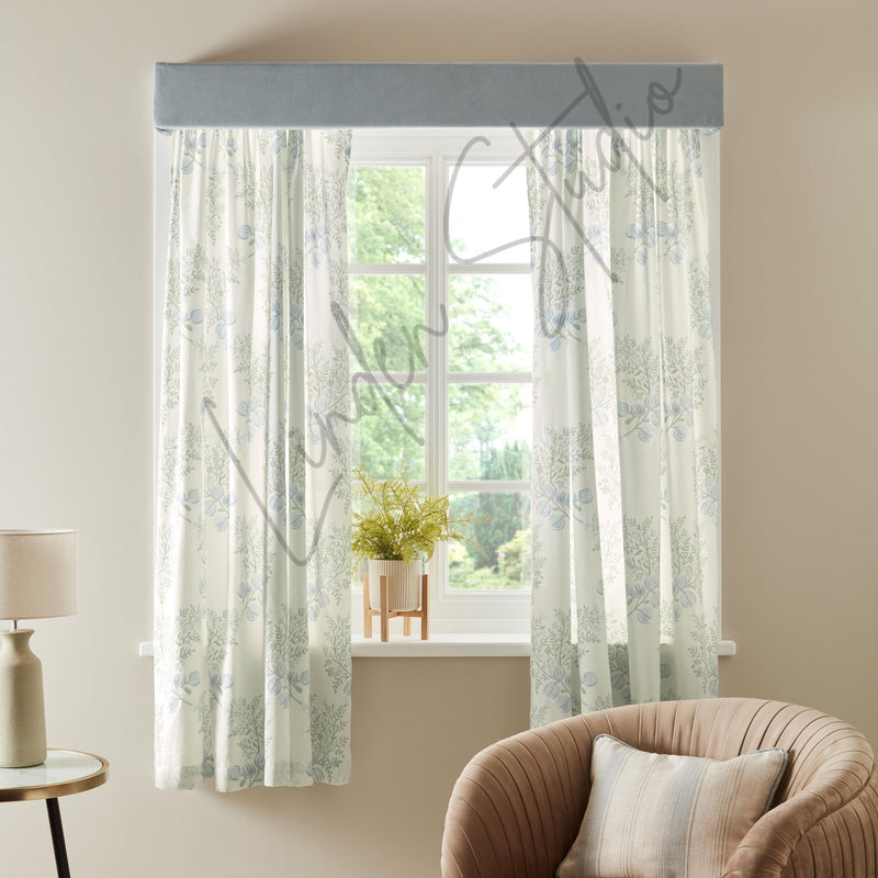 Sheer curtains with a floral pattern in a living room setting.